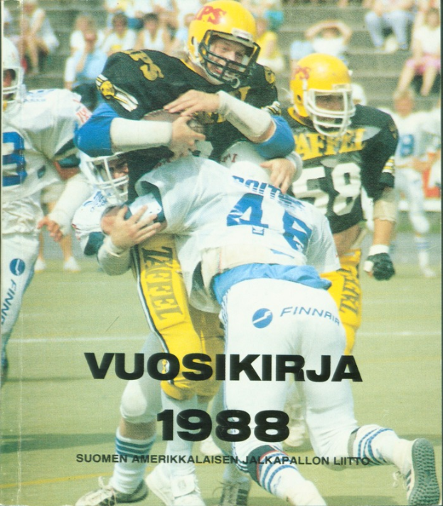 Eine Gruppe von Menschen in Sportbekleidung und Helmen, die Fußball auf einem Feld spielen, mit einigen Personen, die auf einer Treppe im Hintergrund sitzen; Text unten lautet "Vuosikirja 1988 - Suomen Amerikkaisen Jalkapallon Liitto".